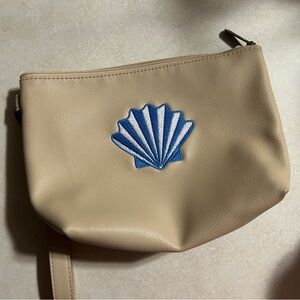 Seashell embroidered ThirtyOne tapered pouch with wrist strap, tan.